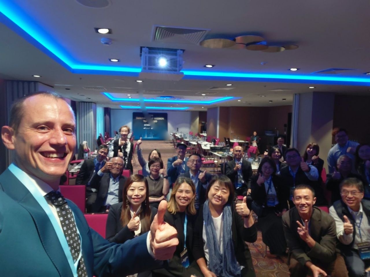 Łukasz Czajkowski of Polska Izba Dual Use takes a selfie with the Taiwanese delegation at the NYX Hotel, Warsaw