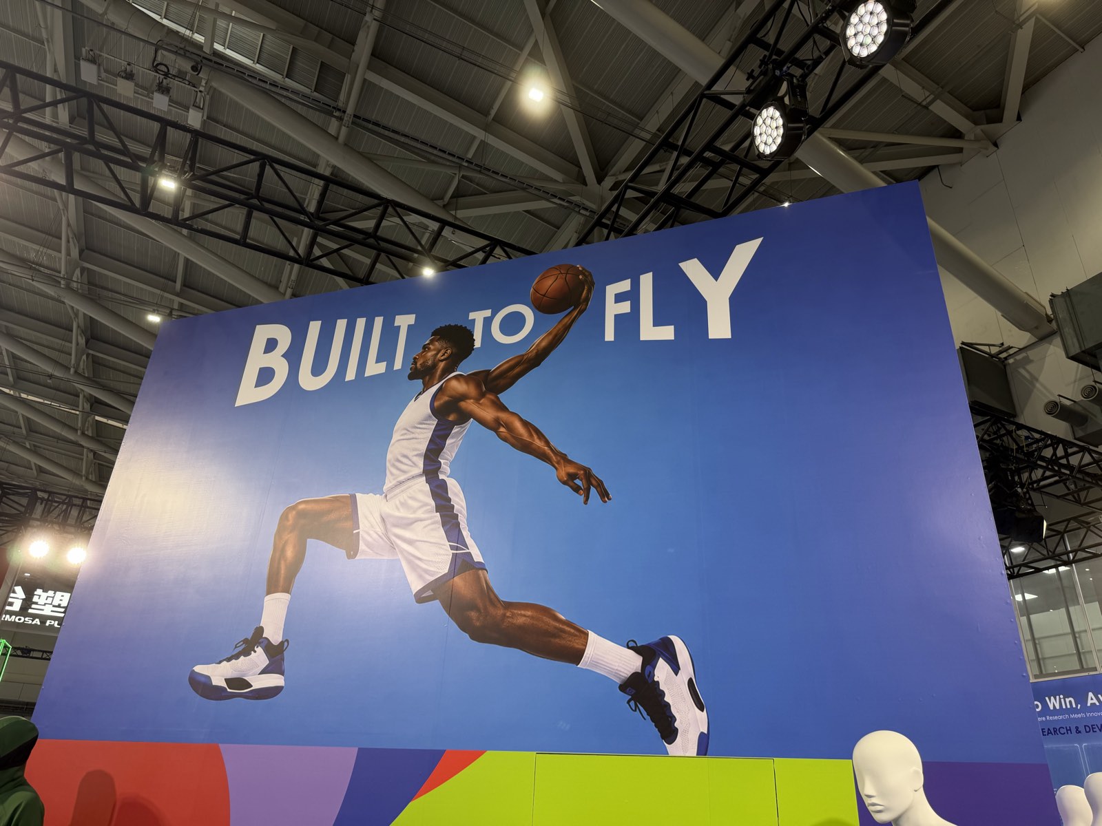 Large blue panel with a basketball player mid-dunk and the headline BUILT TO FLY